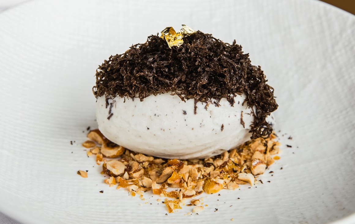a bowl of truffle gelato topped with truffle shavings